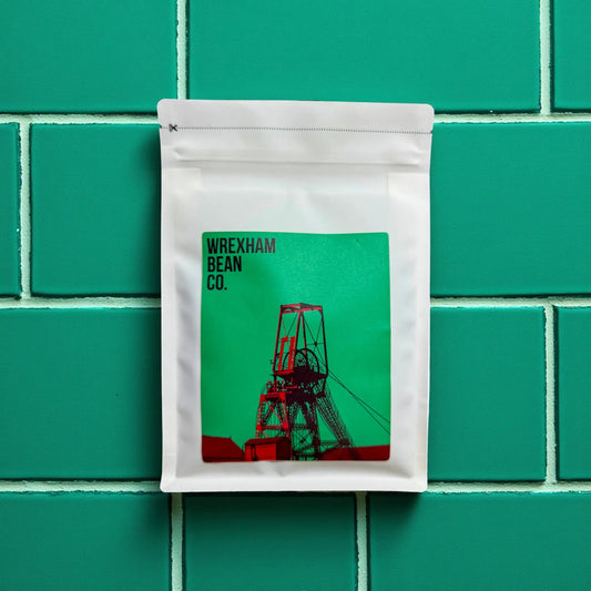 Burundi and Brazilian blend coffee lying on teal coloured tiles