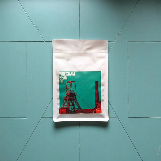 Burundi and Brazilian blend coffee lying on teal coloured tiles